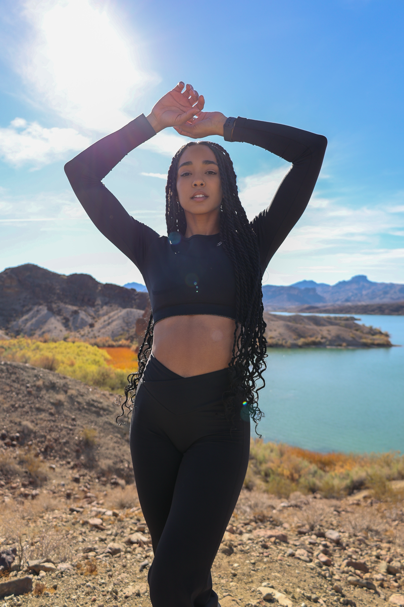 The coach is posing with her confidence with beautiful background.